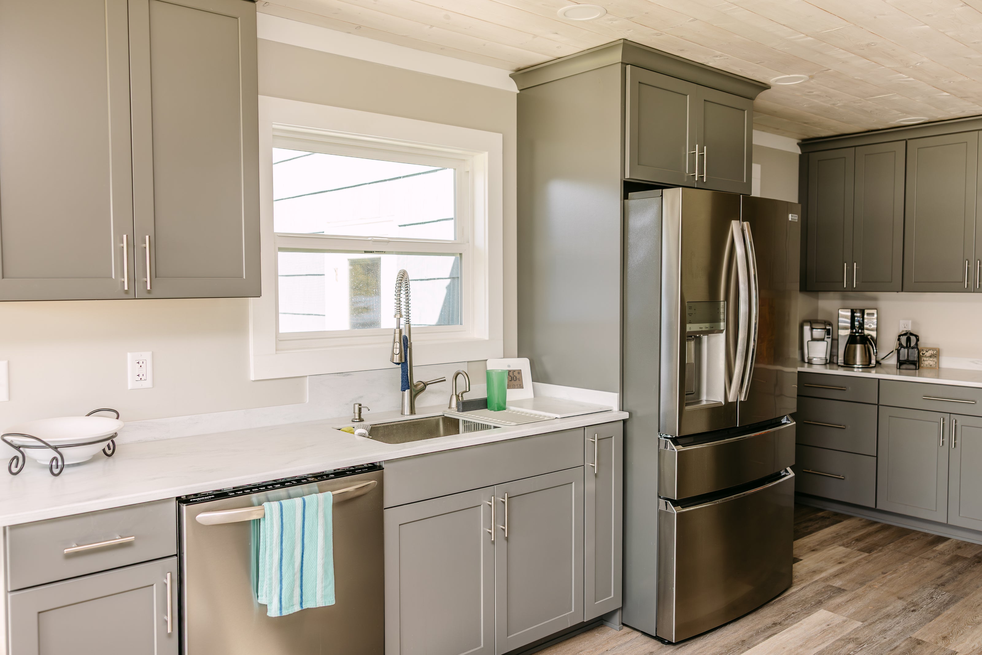 modern kitchen with gray cabinetry, stainless steel appliances