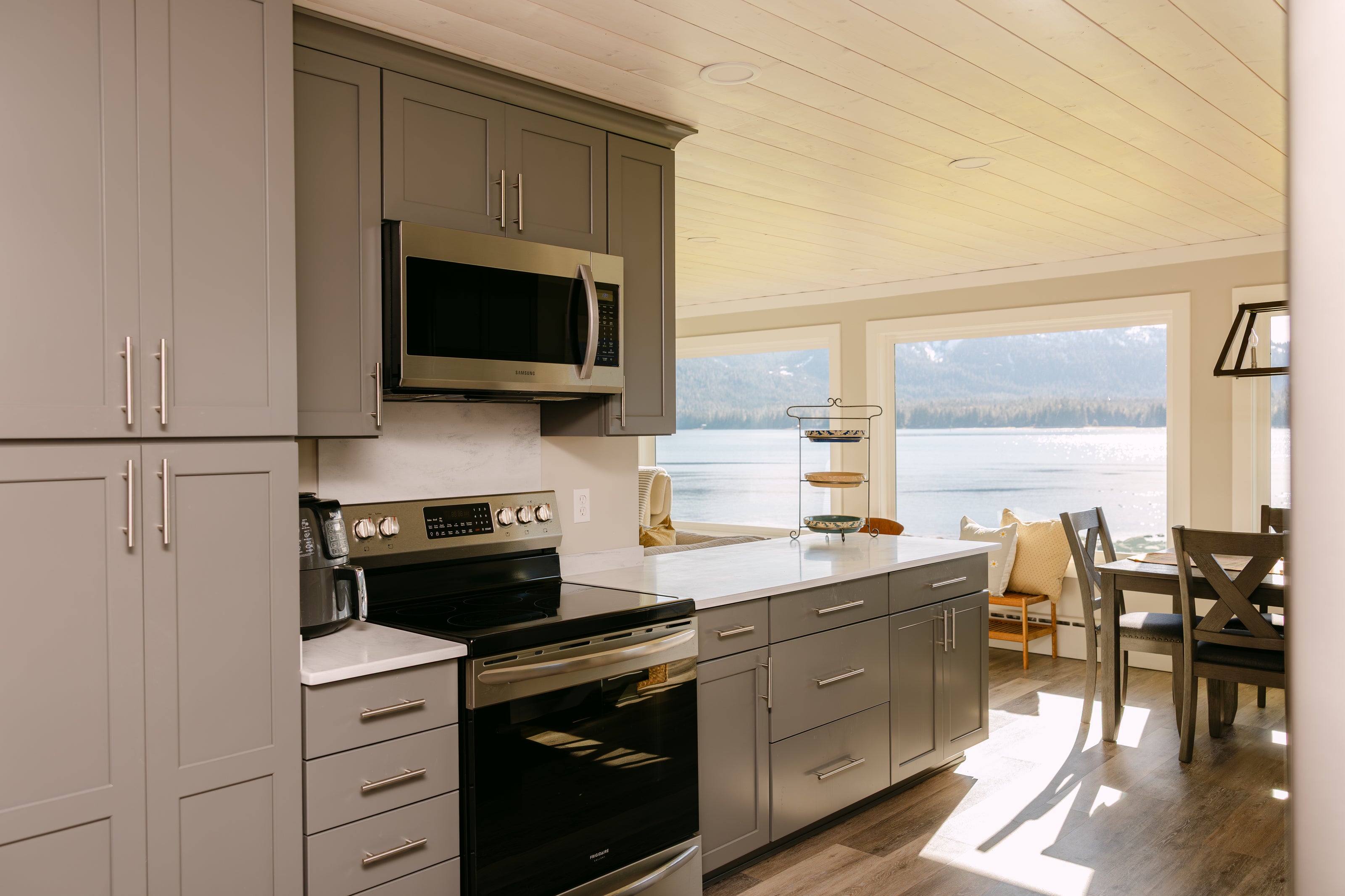 modern kitchen with gray cabinetry, stainless steel appliances