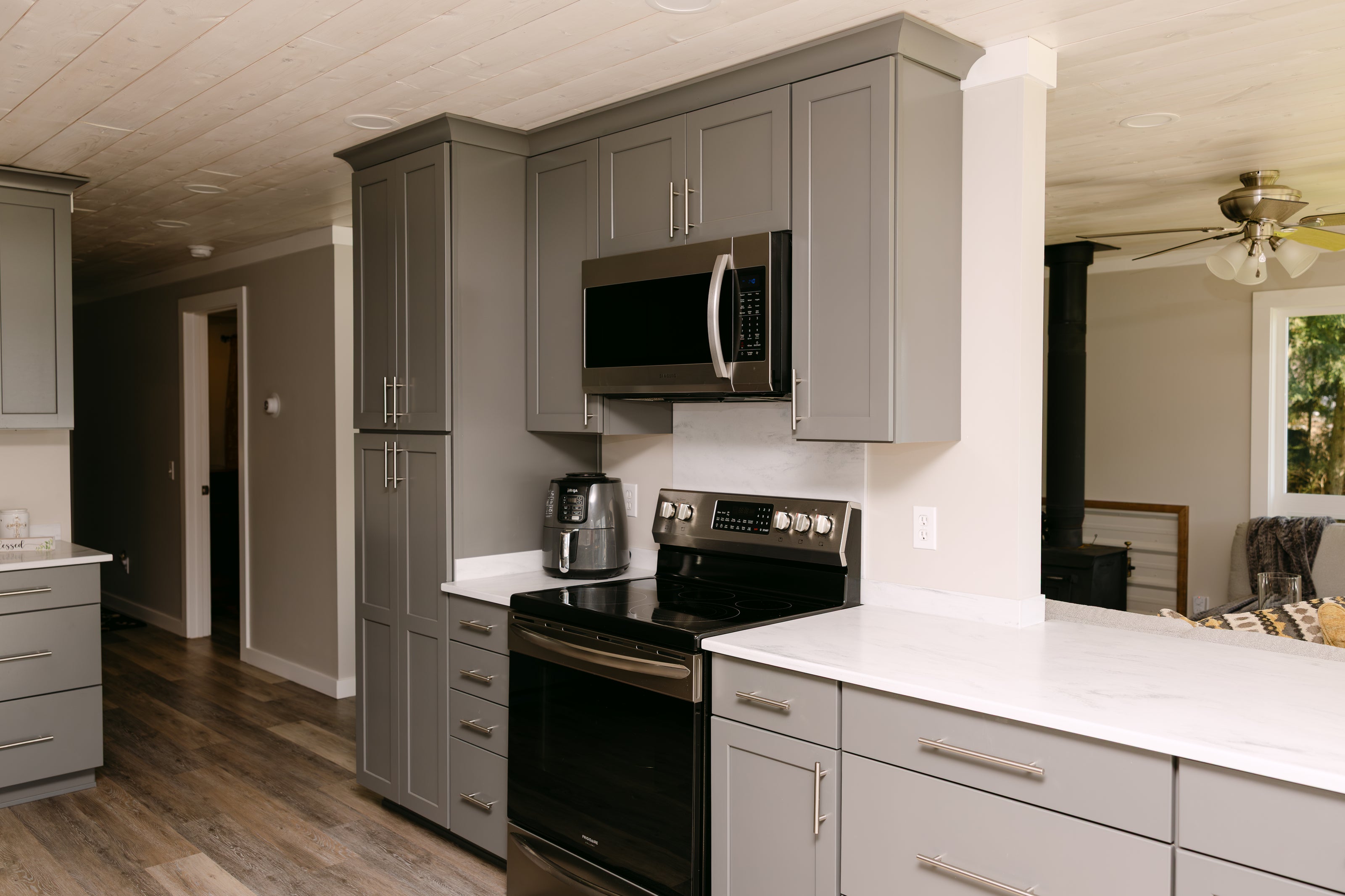 Renovated kitchen with new gray cabinets and appliances
