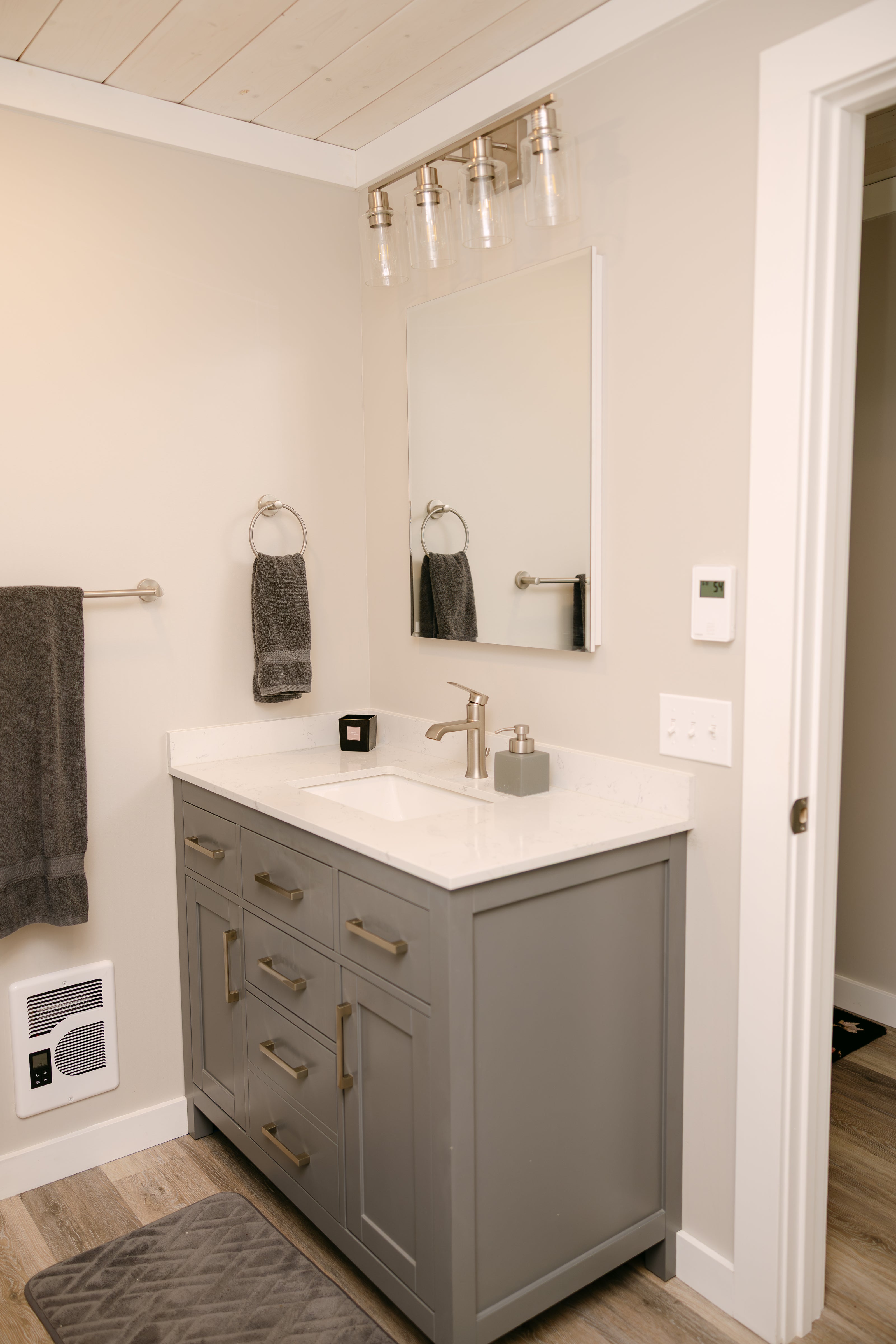 modern bathroom featuring a grey vanity with a single sink